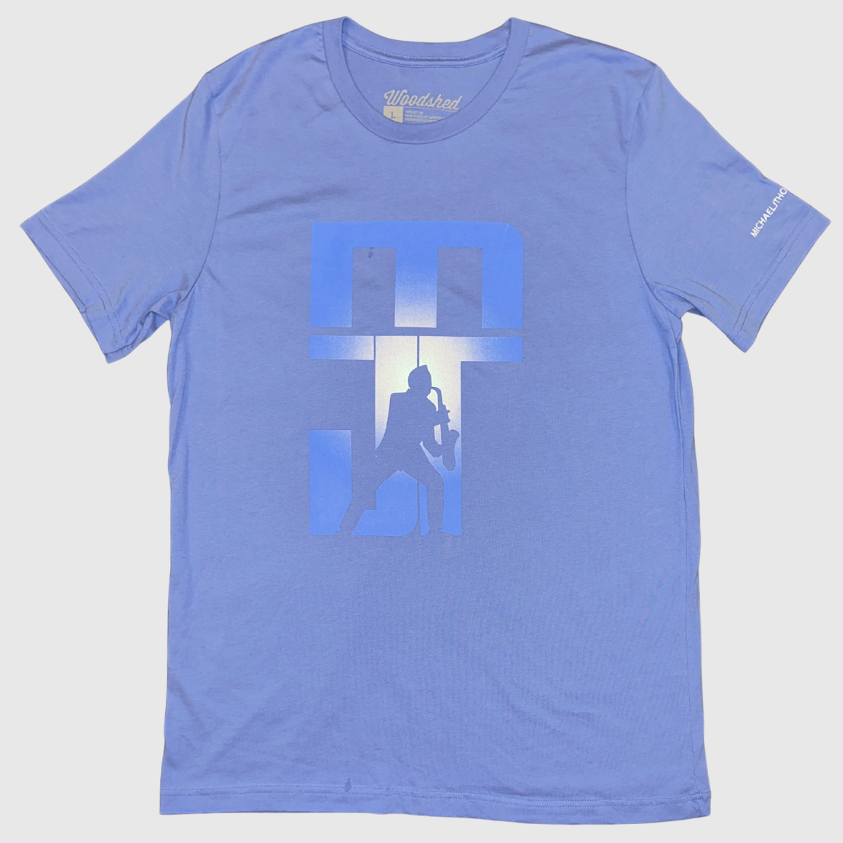 Blue t-shirt with graphic design on a light gray background